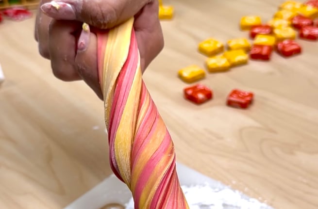 Close up image of the edible slime being twisted so the colors mix together.